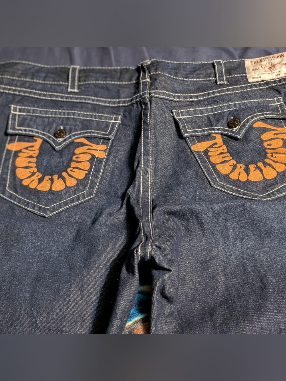 True Religion Men’s Dark Indigo Jeans with Orange Pocket  Embroidered Logo
